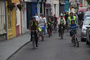 People of all ages cycling together along a street in Clonakilty, Co. Cork