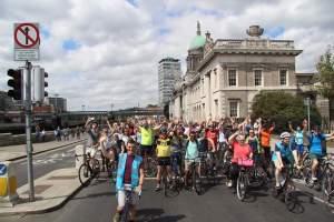 Large group of cyclists filling a Dublin street by a Georgian building during a Liffey Cycle demonstration