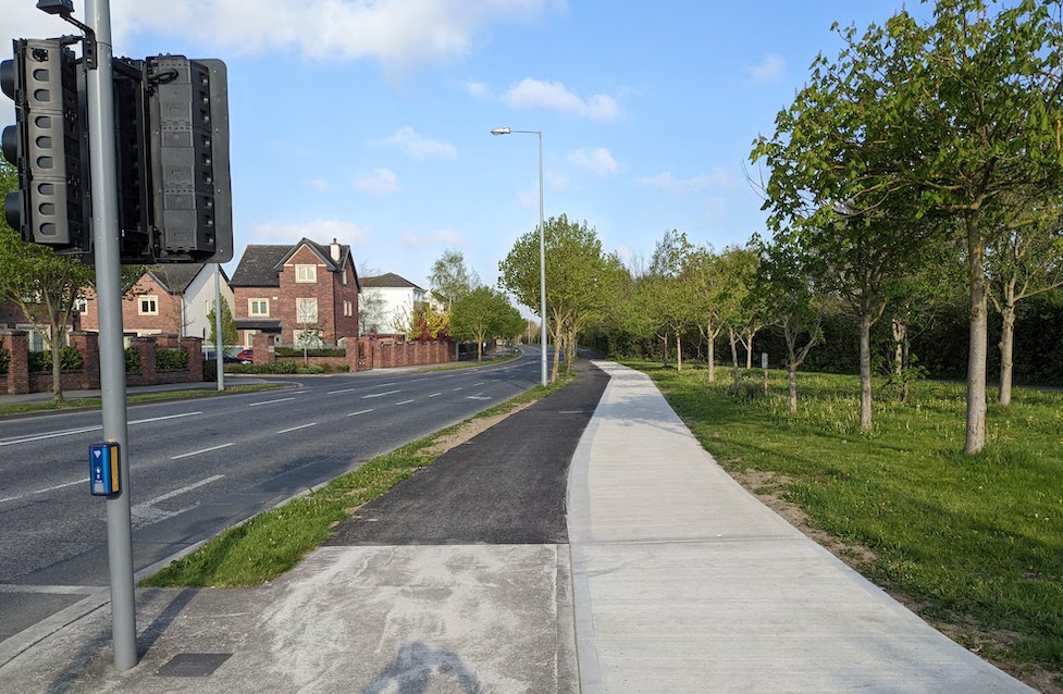 Newly upgraded asphalt cycle track running beside a separate concrete footpath on the Meadowbrook Link Road