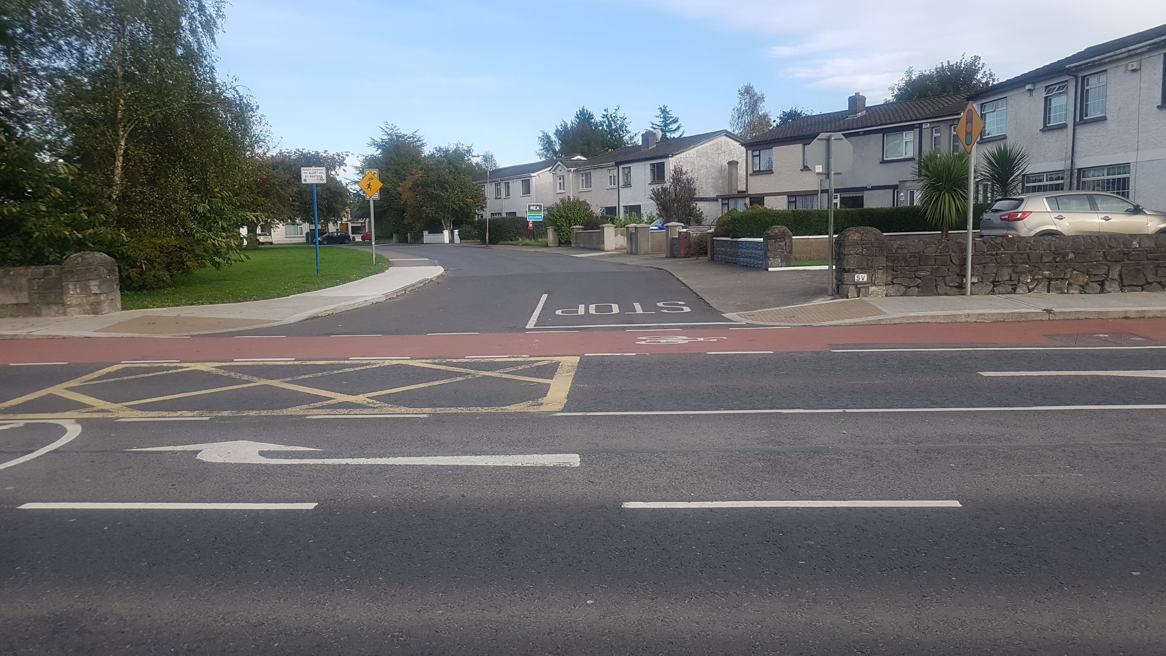 Entrance to Railpark estate in Maynooth seen across the road, with junction, red cycle lane and housing beyond